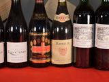 several bottles of wine are lined up on a table