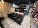 a picture of a salon with a lot of chairs in it