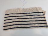 a white and black striped sweater hanging on a hanger
