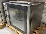 a small oven sitting on a pallet in a warehouse