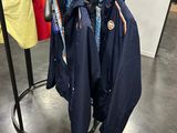 three jackets hanging on a rack in a clothing store