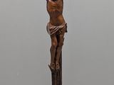 statue of jesus on the cross with a bird on top of it
