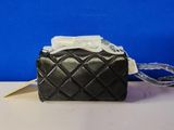 the small black purse has a white bow on top of it