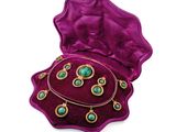 an image of a purple velvet box with a necklace and earrings in it