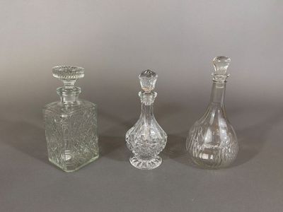 three clear glass bottles sitting next to each other on a table