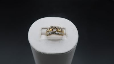 a close up of a ring on a white stand with a black background
