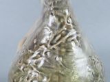a silver vase that is sitting on a table