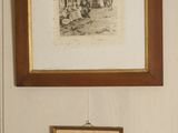 two pictures hanging on the wall above a toilet