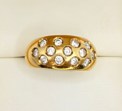 a close up of a gold ring with diamonds on it