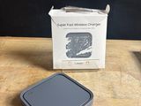 an apple wireless charger sitting on top of a wooden table next to a box