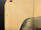 a piece of cardboard with a picture of a man ' s face on it