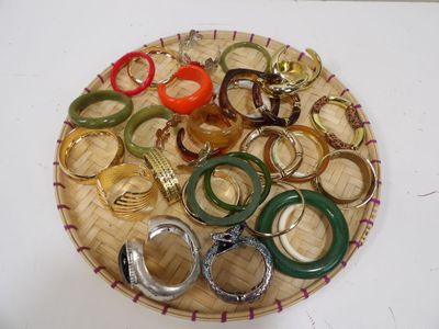 many different colored rings on a basket on a table