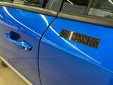 a blue car with a sticker on the side of it