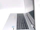 a silver laptop with a blue sticker on the screen