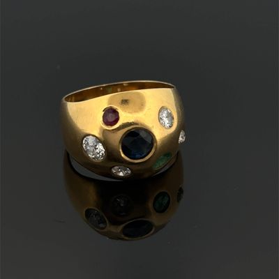 a close up of a gold ring with three different colored stones