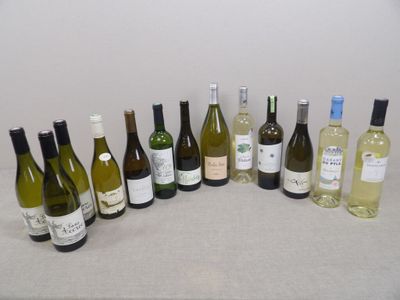 bottles of wine are lined up on a table in a row