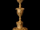 a gold vase on a black background with a black background