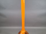 orange glass vase on a gray background with a gray background