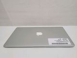 a silver apple laptop sitting on a white table