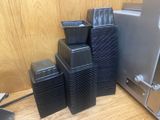 a stack of black plastic containers sitting on a table