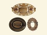 three different types of metal buttons and a clasp