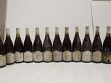 several bottles of wine are lined up in a row on a table