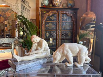 two figurines of a bear and a bear cub on a table