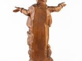 wooden statue of a woman holding her hands out with her arms outstretched