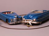 two toy cars sitting next to each other on a table