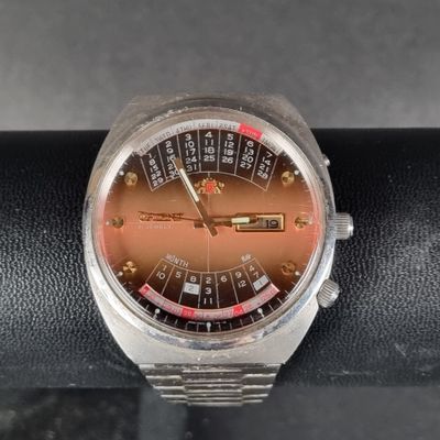 an image of a close up of a wrist watch on a black surface