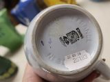 a person holding a cup that has a sticker on it