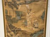 a picture of a painting on the wall next to a vase