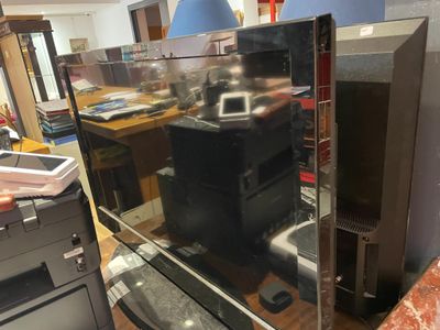 a glass display case with a coffee maker inside of it