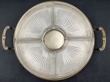 a silver tray with four compartments on it on a black surface