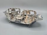 a silver plate with two cups on it on a table