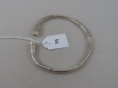 a silver bracelet that has a tag on it