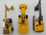 three toy construction vehicles that are next to each other
