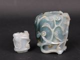 a small vase and a smaller one sitting on a table