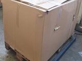 a cardboard box sitting on a pallet in a room