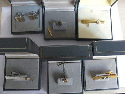 five different types of cuff watches in a display case