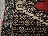 un tapis orné d'une croix rouge posé sur un parquet