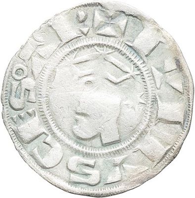 a close up of a silver coin with a face on it
