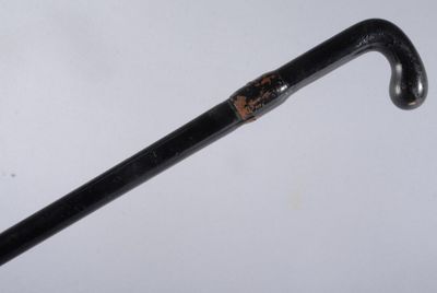 a close up of a cane with a handle on a table