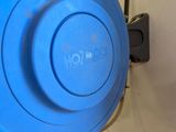 a close up of a blue bowl on a wall