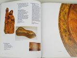 an open book with a picture of a statue and other items on it
