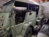 a military vehicle that is parked in a garage