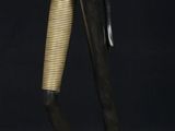an image of a bronze statue of a woman holding a fan