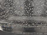 a glass of water with bubbles in it on a table