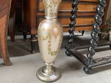a vase that is sitting on a table next to a chair