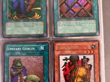 four different cards in a plastic case on a table